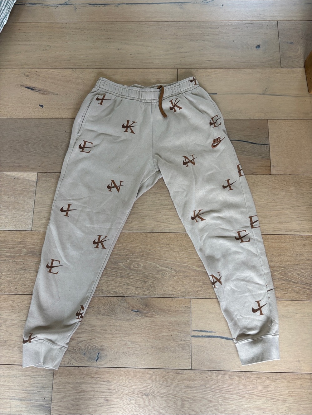 Nike Mens Small Beige Joggers with Brown Logo Print